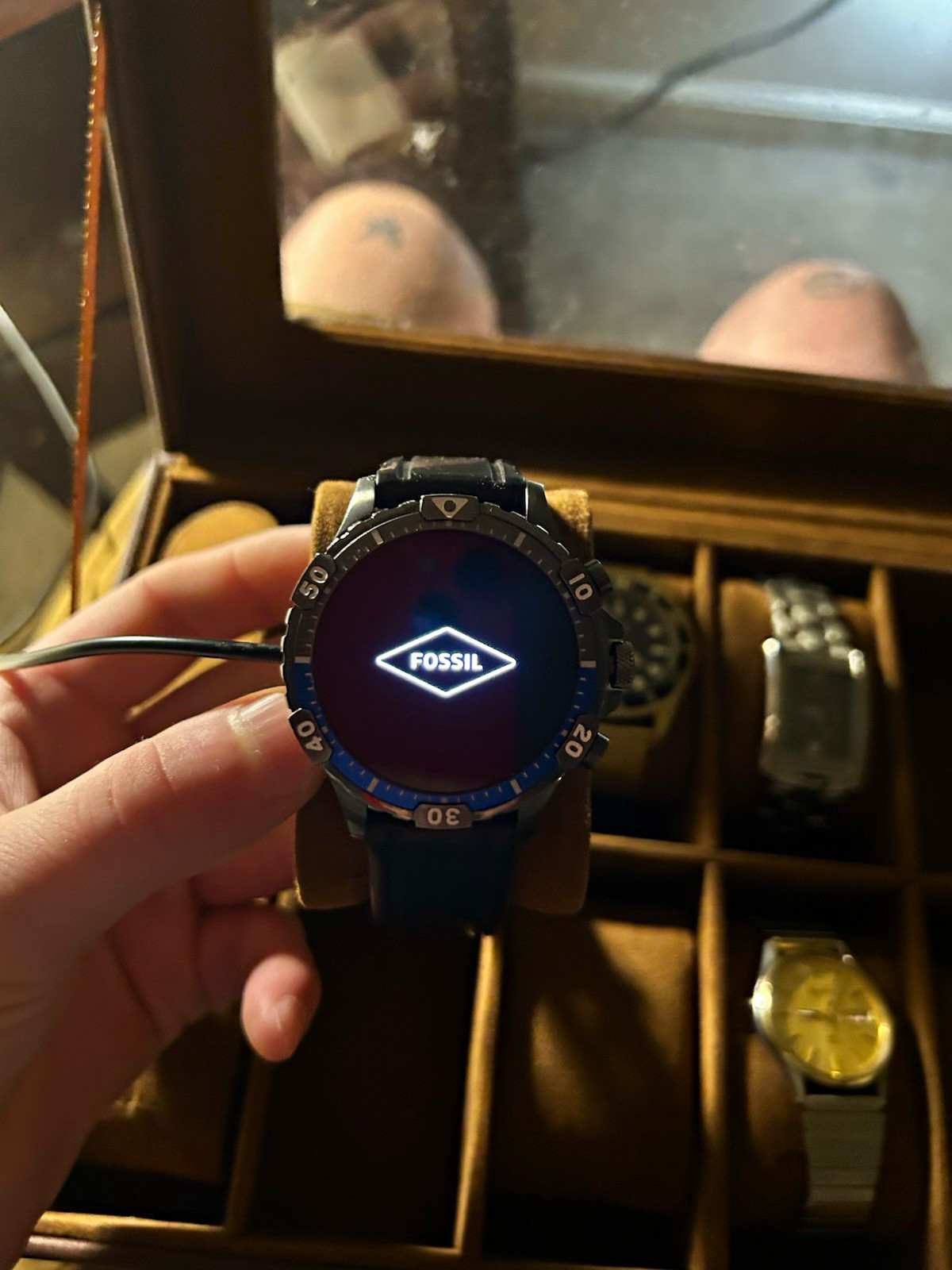 Fossil Gen 5 Garrett HR smartwatch with a blue bezel and black silicone strap
