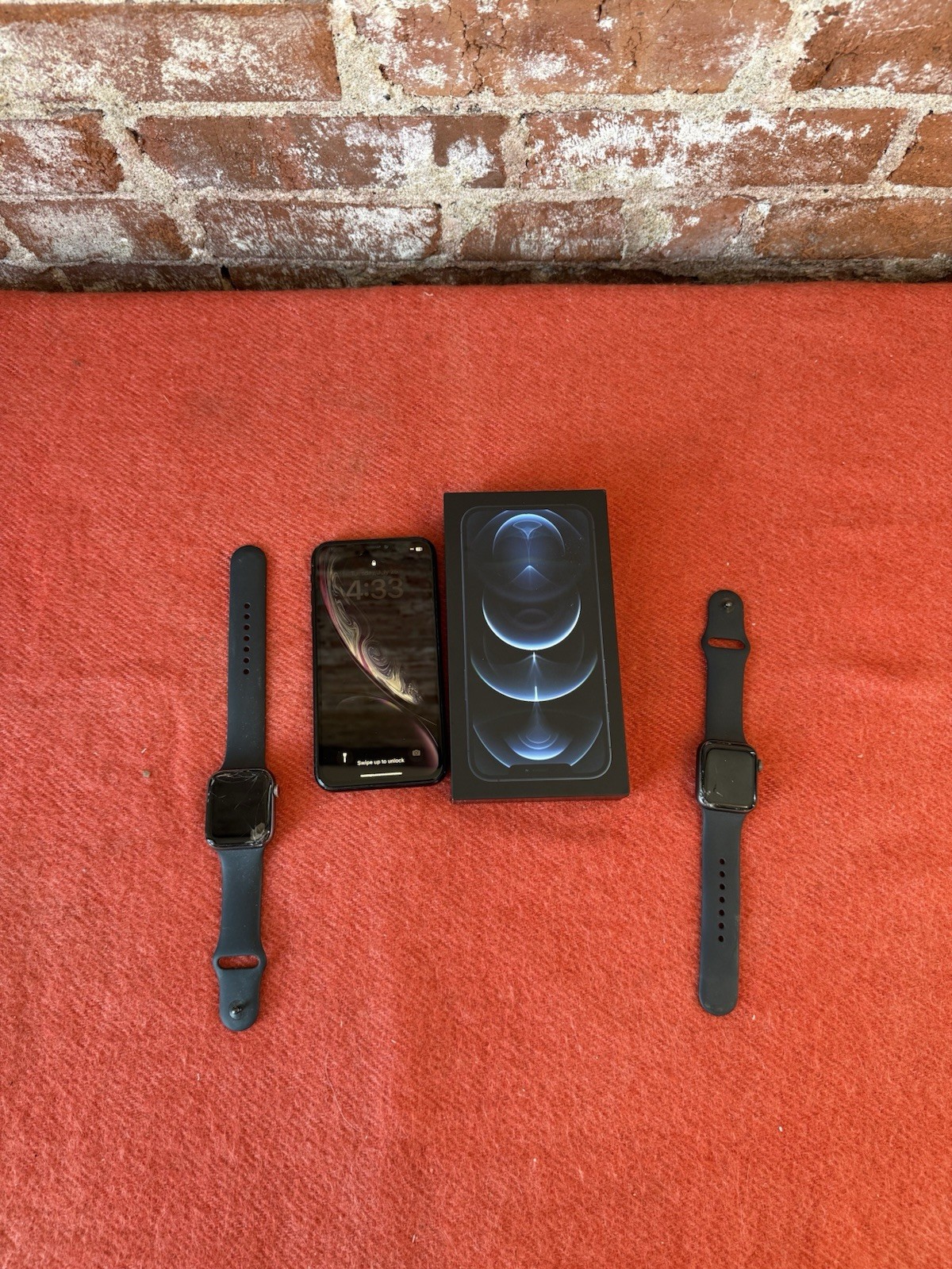 Two apple iPhones and two Apple Watches parts non working storage unit find