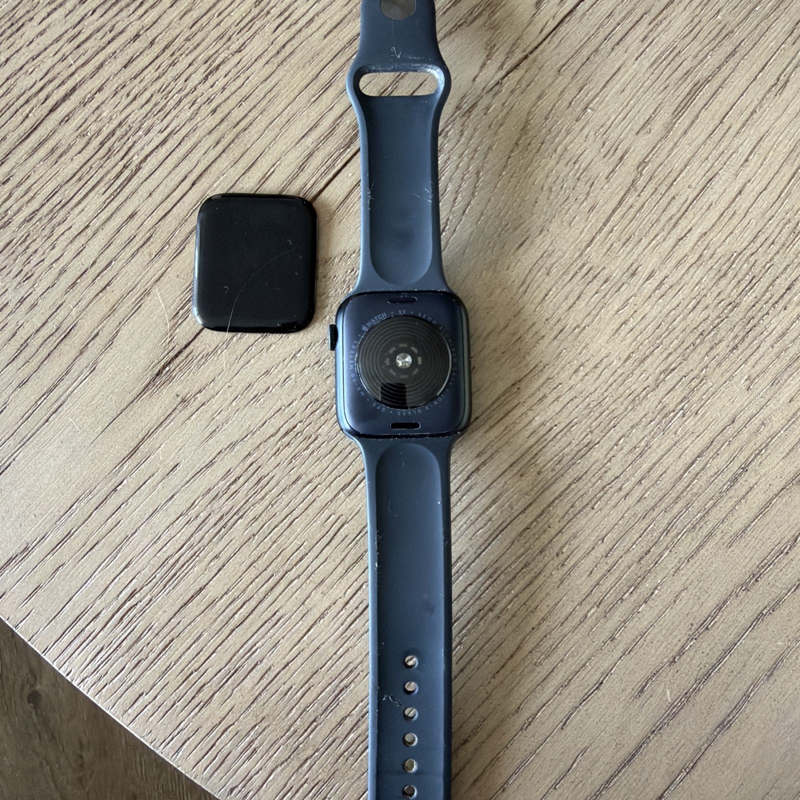 Apple Watch SE 44mm GPS Space Gray Aluminum Case with Black Sport Band.