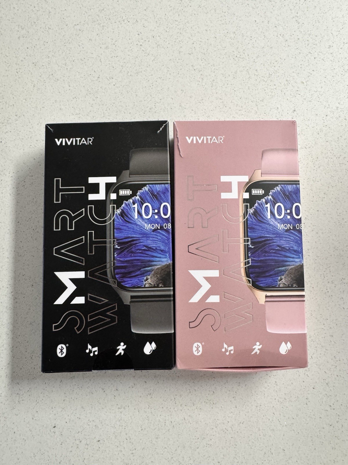2 Vivitar Smartwatch (New in Box) 1 Black & 1 Pink Fitness Tracker + Bluetooth